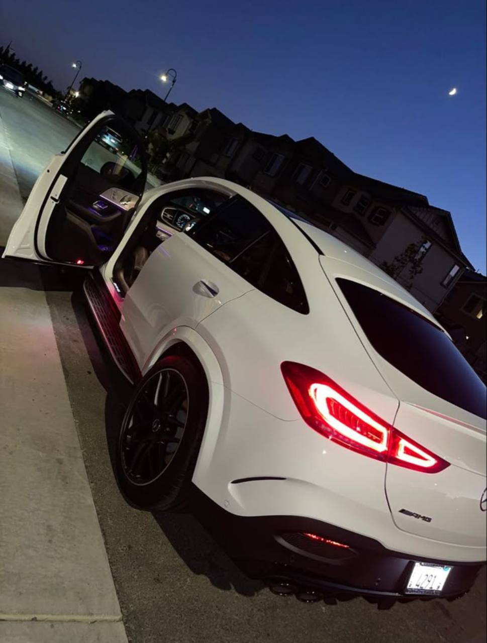 White Mercedes-Benz GLE rear profile with open door